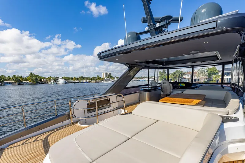 Slide: The Image of Luxurious 2023 Princess Y72 yacht deck with seating, overlooking serene waterfront. - 32