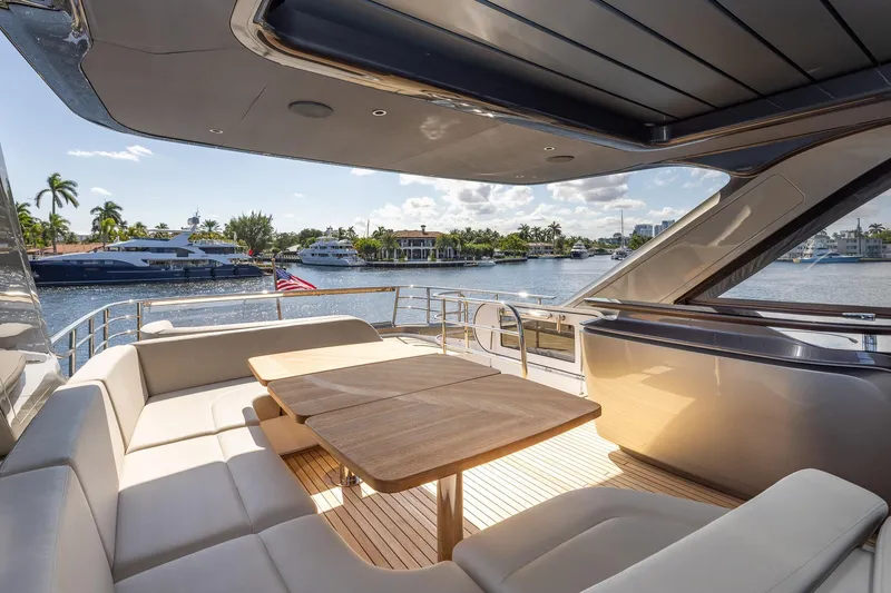 Slide: The Image of Luxurious 2023 Princess Y72 yacht deck with elegant seating and scenic waterfront view. - 34