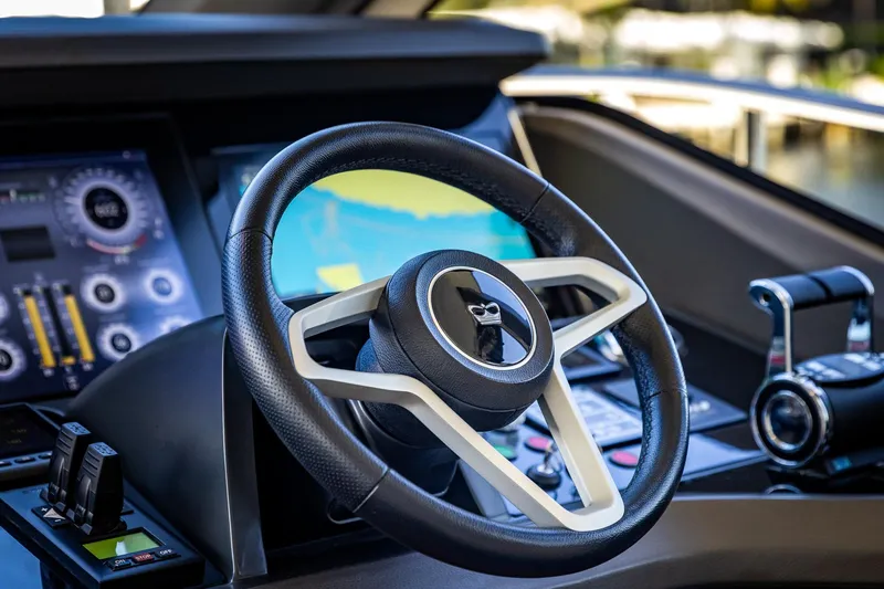 Slide: The Image of Luxurious 2023 Princess Y72 yacht helm with advanced navigation controls and sleek steering wheel. - 45