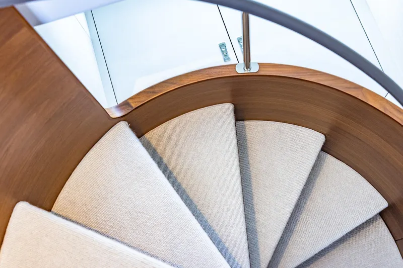 Slide: The Image of Curved wooden staircase with carpeted steps on a 2023 Princess Y72 yacht. - 49