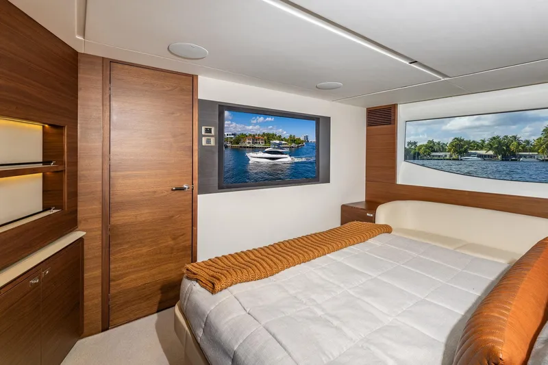 Slide: The Image of Luxurious 2023 Princess Y72 yacht bedroom with elegant wood finishes and scenic window views. - 51