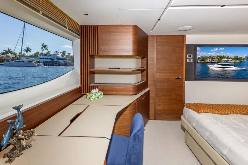 Slide: The Image of Luxurious interior of 2023 Princess Y72 yacht with elegant wood finishes and scenic window view. - 54