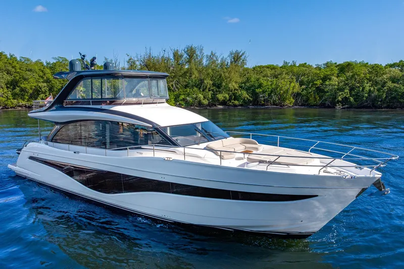 Slide: The Image of Luxurious 2023 Princess Y72 yacht cruising on serene waters, surrounded by lush greenery. - 6