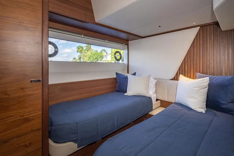 Slide: The Image of Luxurious cabin interior of 2023 Princess Y72 yacht with twin beds and elegant wood paneling. - 61