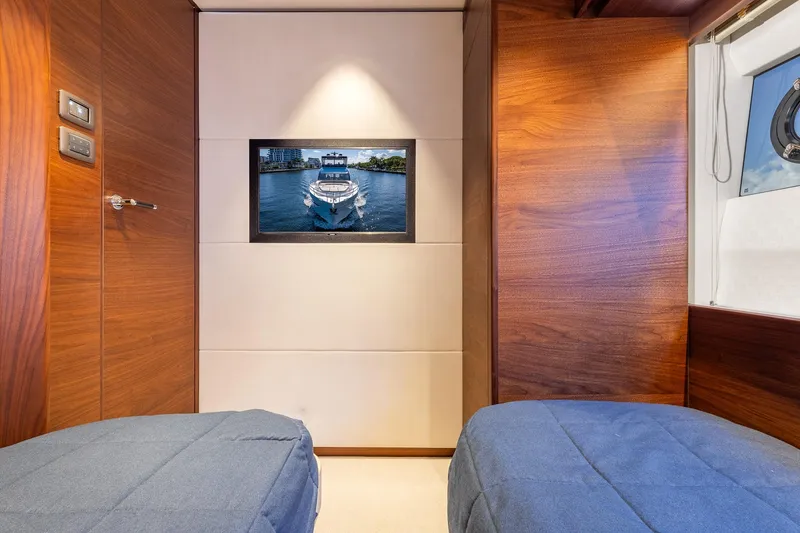 Slide: The Image of Luxurious 2023 Princess Y72 yacht cabin with wood paneling and modern decor. - 63