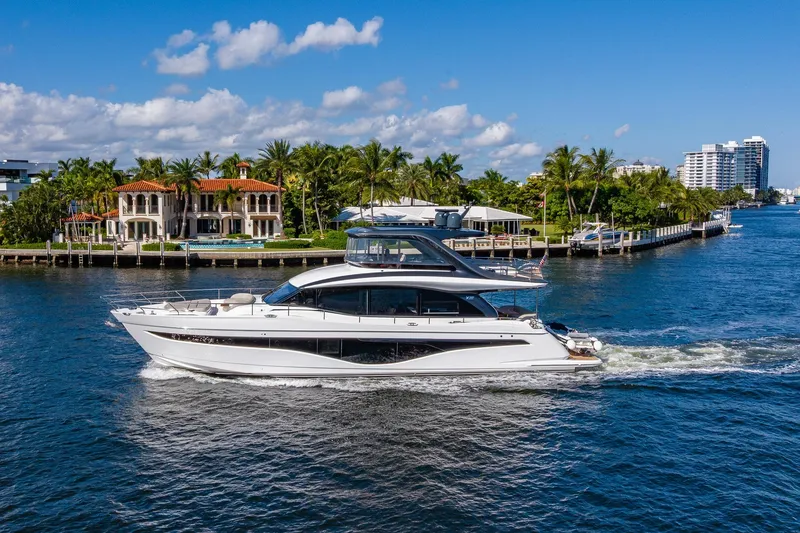 Slide: The Image of Luxurious 2023 Princess Y72 yacht cruising on a sunny day near waterfront homes. - 9