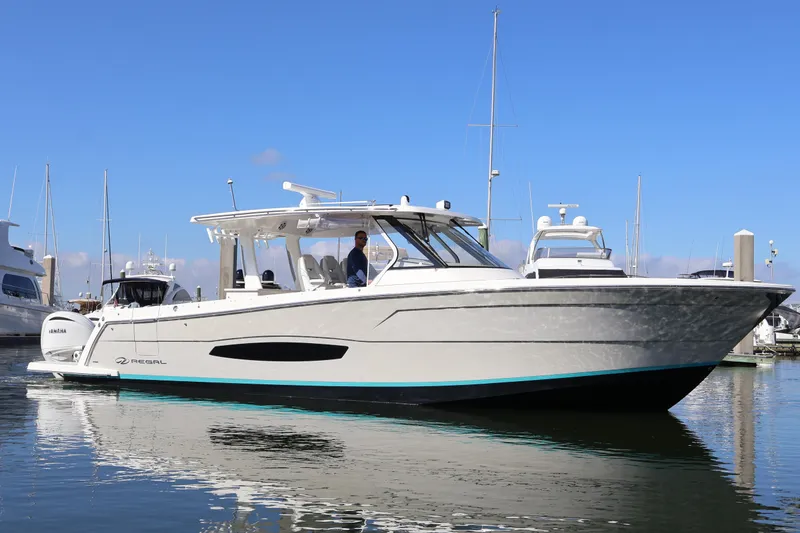 Slide: The Image of 2022 Regal 38 SAV boat docked, featuring Seakeeper stabilization technology. - 0