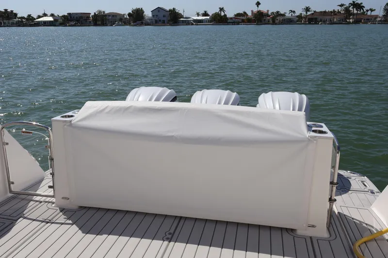 Slide: The Image of 2022 Regal 38 SAV boat with cover, near construction site and tropical setting. - 18