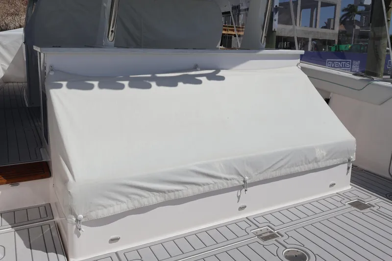 Slide: The Image of 2022 Regal 38 SAV boat with covered deck, poolside setting in background. - 22