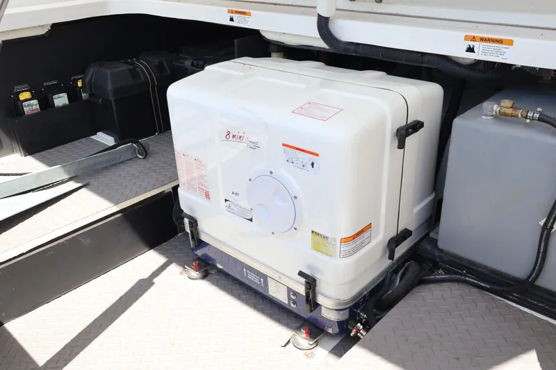 Slide: The Image of Open engine compartment of 2022 Regal 38 SAV boat, showcasing equipment and storage. - 26
