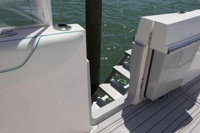Slide: The Image of 2022 Regal 38 SAV boat with white seating and triple outboard engines. - 31