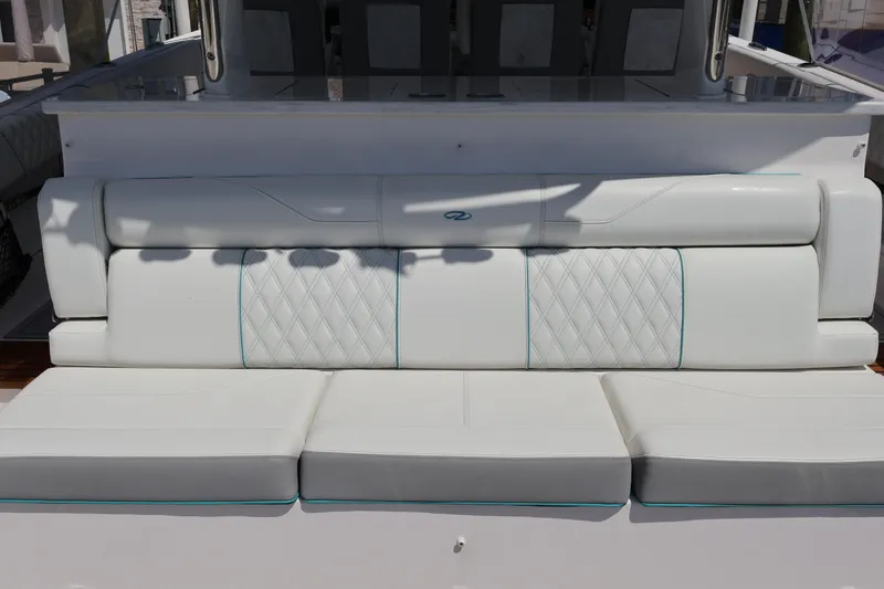 Slide: The Image of 2022 Regal 38 SAV boat seating area with luxurious white and gray upholstery. - 35