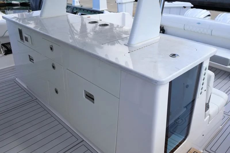 Slide: The Image of 2022 Regal 38 SAV boat interior with mounted TV and seating area. - 41