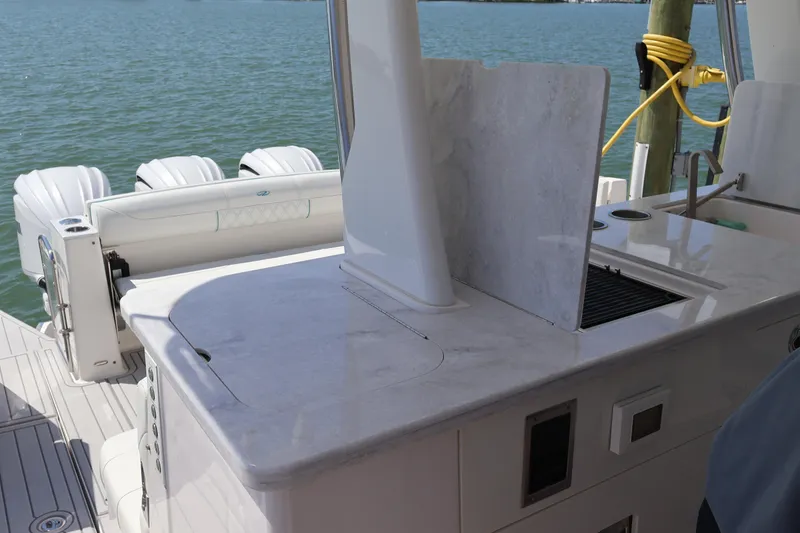 Slide: The Image of 2022 Regal 38 SAV boat interior with sleek countertop and dual outboard engines. - 44