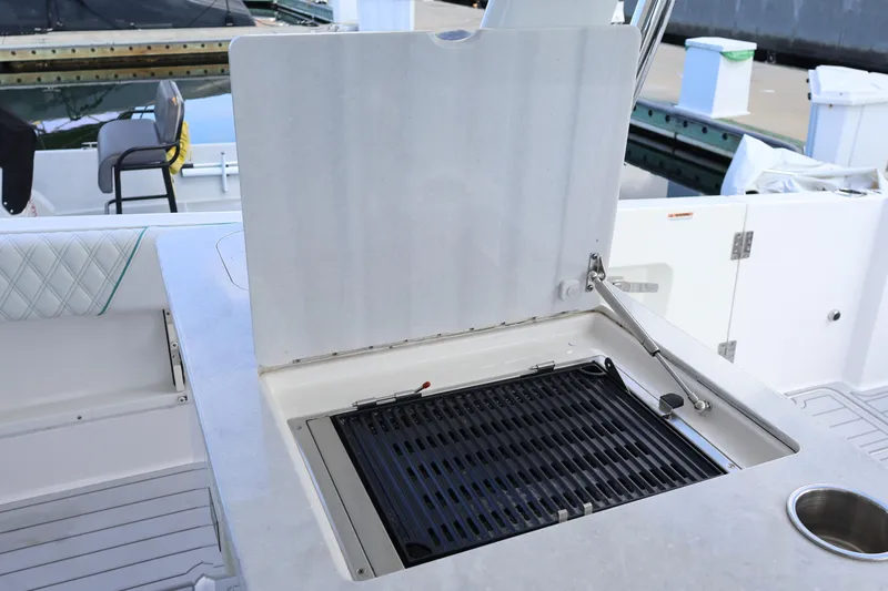 Slide: The Image of 2022 Regal 38 SAV boat with sleek outdoor kitchen and powerful engines. - 45