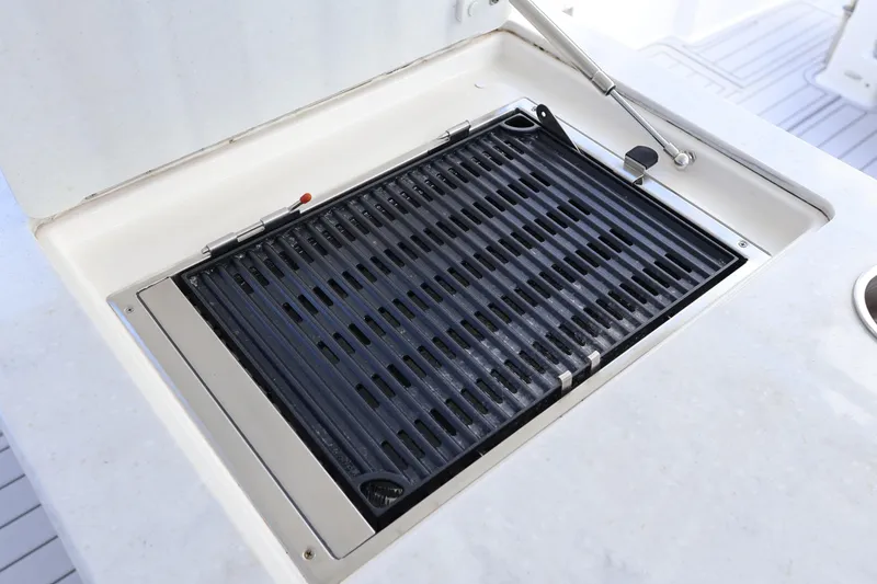 Slide: The Image of Outdoor grill on 2022 Regal 38 SAV boat, dockside view. - 46