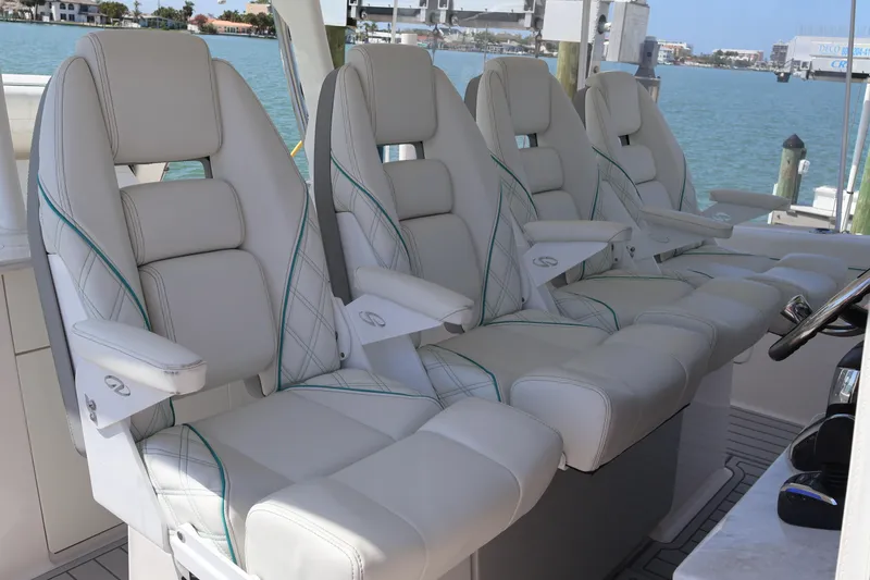 Slide: The Image of Luxury seating on 2022 Regal 38 SAV boat, featuring plush white leather chairs. - 53