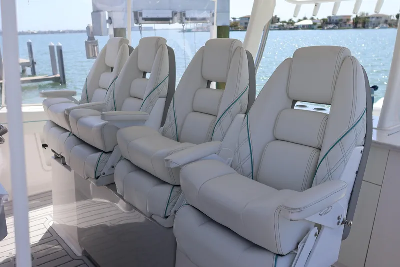 Slide: The Image of Luxurious seating on 2022 Regal 38 SAV boat with waterfront view. - 54