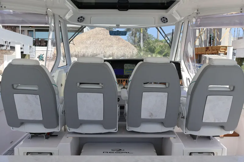 Slide: The Image of Luxurious seating on 2022 Regal 38 SAV boat with waterfront view. - 55