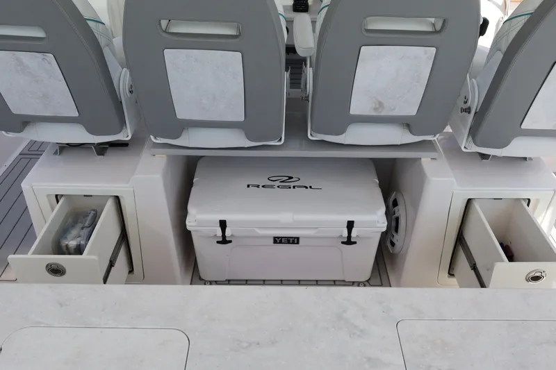Slide: The Image of 2022 Regal 38 SAV boat cockpit with modern controls and cushioned seating. - 58