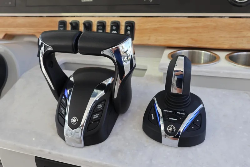 Slide: The Image of 2022 Regal 38 SAV helm with controls, steering wheel, and Garmin navigation system. - 65