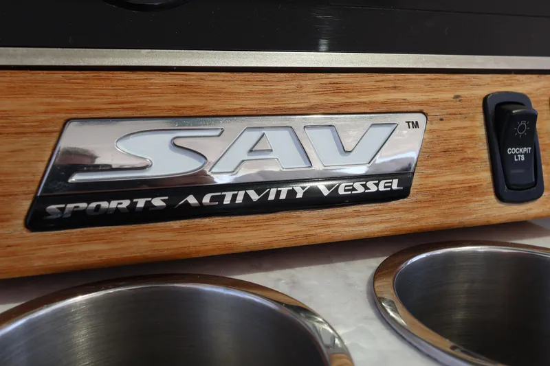 Slide: The Image of 2022 Regal 38 SAV dashboard with controls, cup holders, and unique hand decoration. - 67