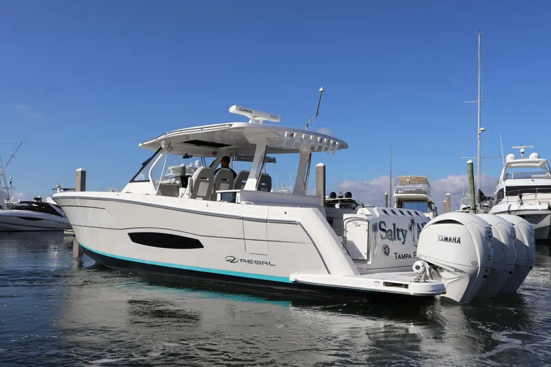 Slide: The Image of 2022 Regal 38 SAV boat with Yamaha engines docked in marina. - 8