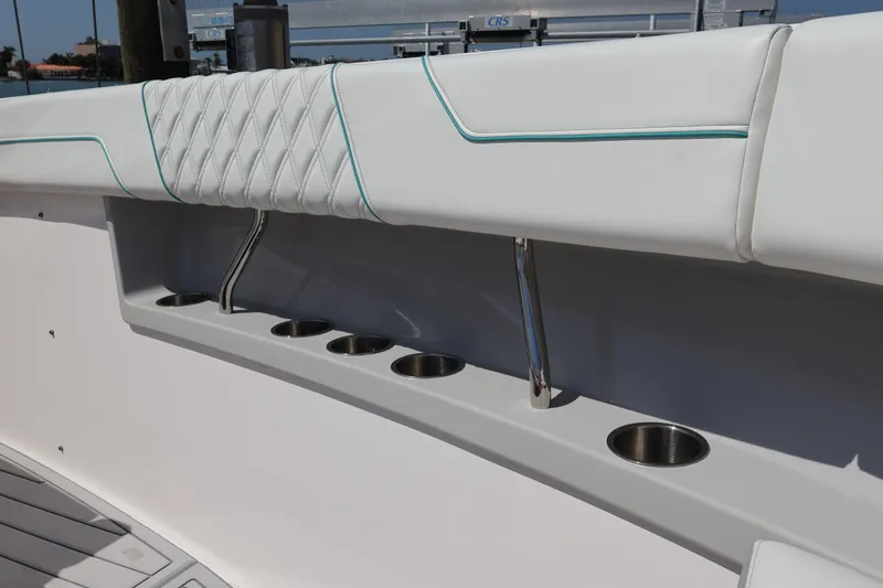 Slide: The Image of 2022 Regal 38 SAV boat seat with logo, white upholstery, outdoor setting. - 91