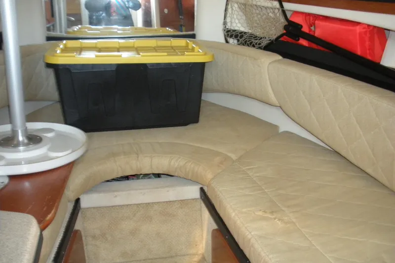 Slide: The Image of Interior of 2006 Sea Ray 260 Sundancer with beige seating and storage box. - 3