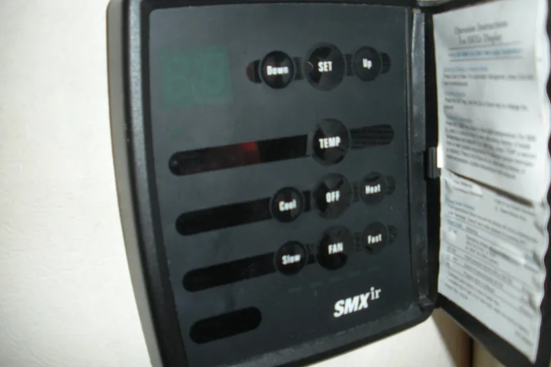 Slide: The Image of Control panel of a 2006 Sea Ray 260 Sundancer boat, featuring temperature and fan settings. - 7