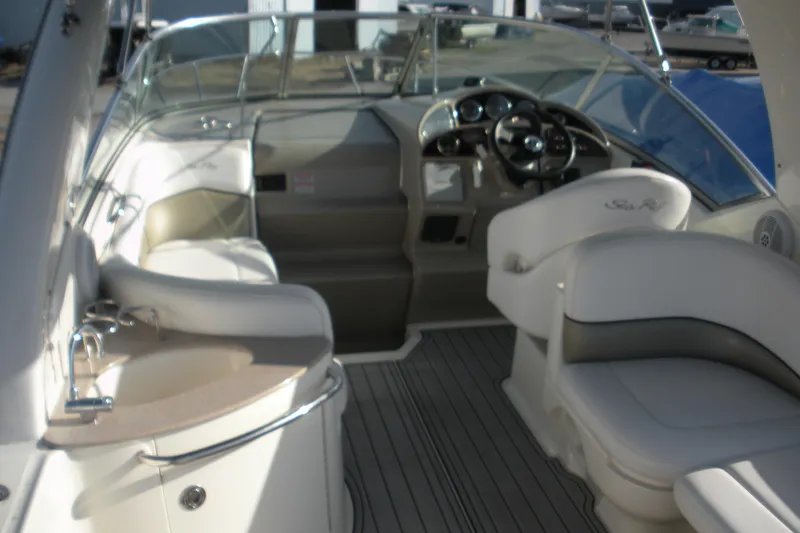 Slide: The Image of 2006 Sea Ray 260 Sundancer boat interior with seating and steering wheel. - 8