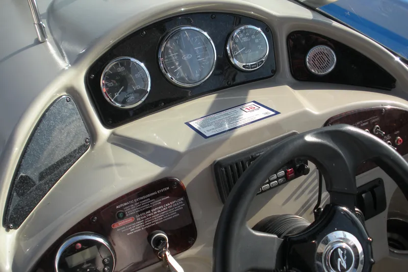 Slide: The Image of Dashboard of a 2006 Sea Ray 260 Sundancer boat with gauges and steering wheel. - 9