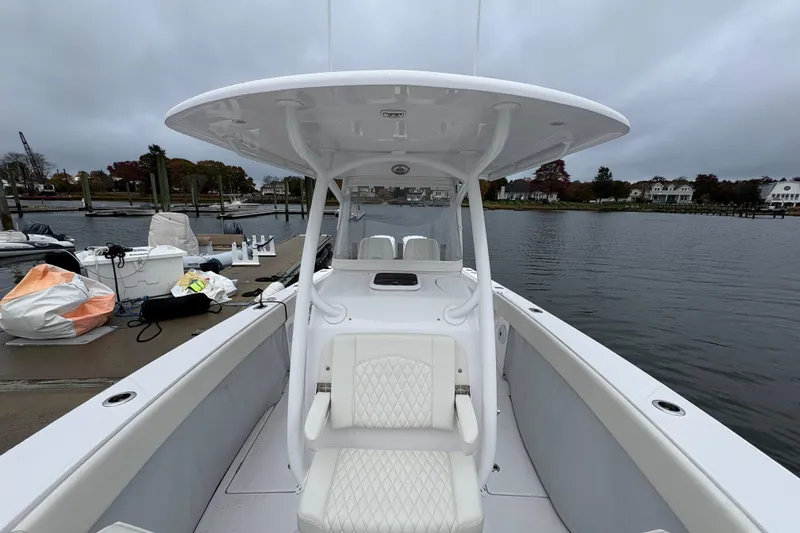 Slide: The Image of 2023 Jupiter 30 boat docked by a serene waterfront, showcasing sleek design and comfortable seating. - 21