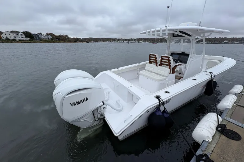 Slide: The Image of 2023 Jupiter 30 boat with Yamaha engines docked on a cloudy day. - 37