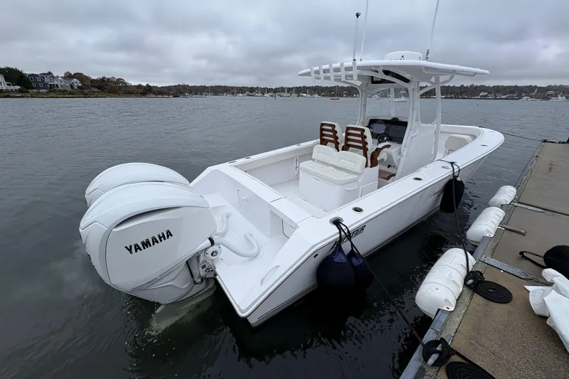 Slide: The Image of 2023 Jupiter 30 boat docked with twin Yamaha engines, overcast sky. - 38