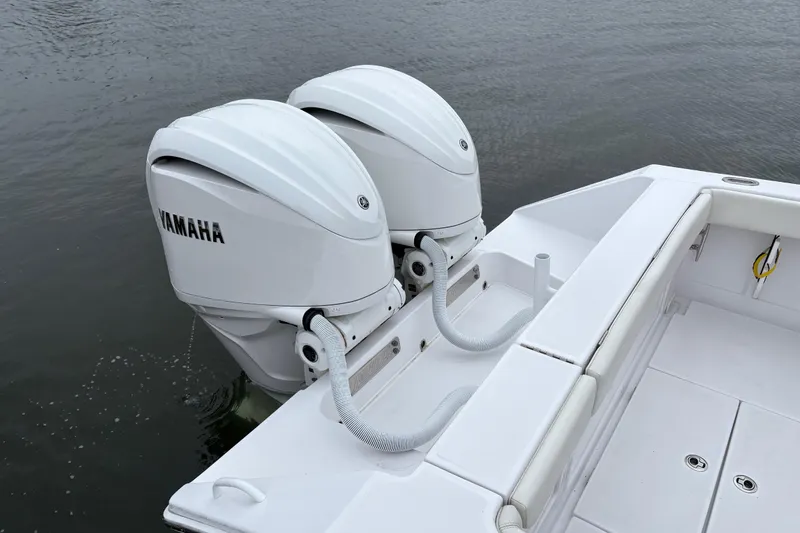 Slide: The Image of 2023 Jupiter 30 boat with dual Yamaha outboard motors on calm water. - 45