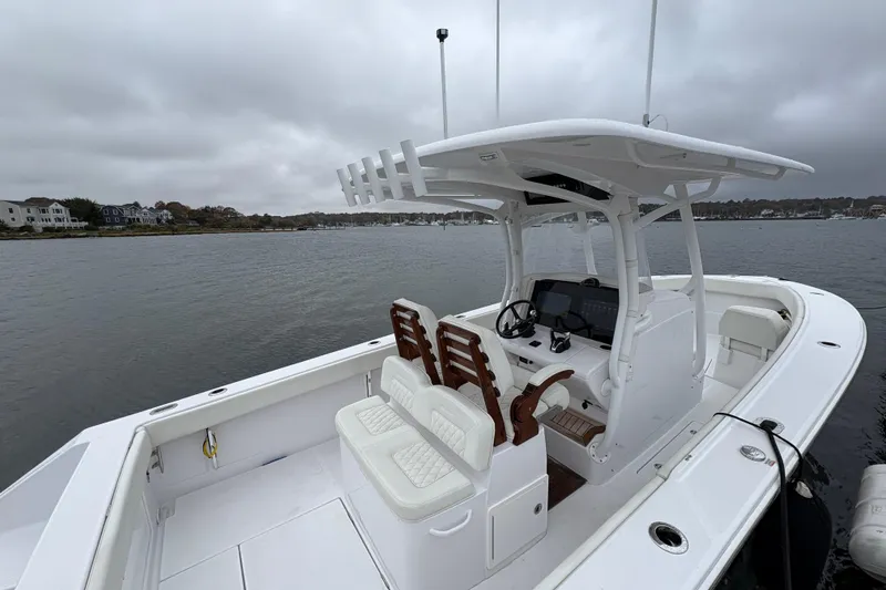 Slide: The Image of 2023 Jupiter 30 boat with dual seats and console on a cloudy day. - 46