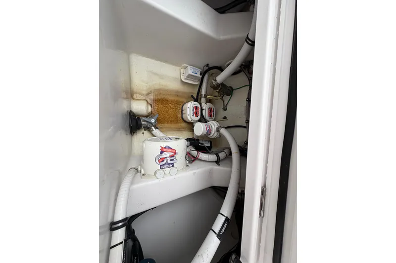 Slide: The Image of 2023 Jupiter 30 boat interior showing plumbing and wiring components. - 54