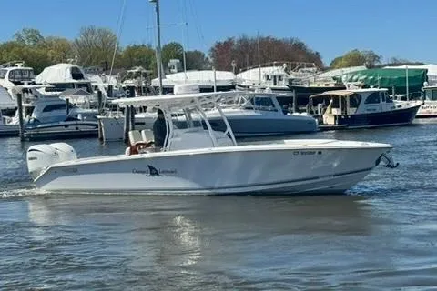 Slide: The Image of 2023 Jupiter 30 boat docked in a marina with other vessels. - 55