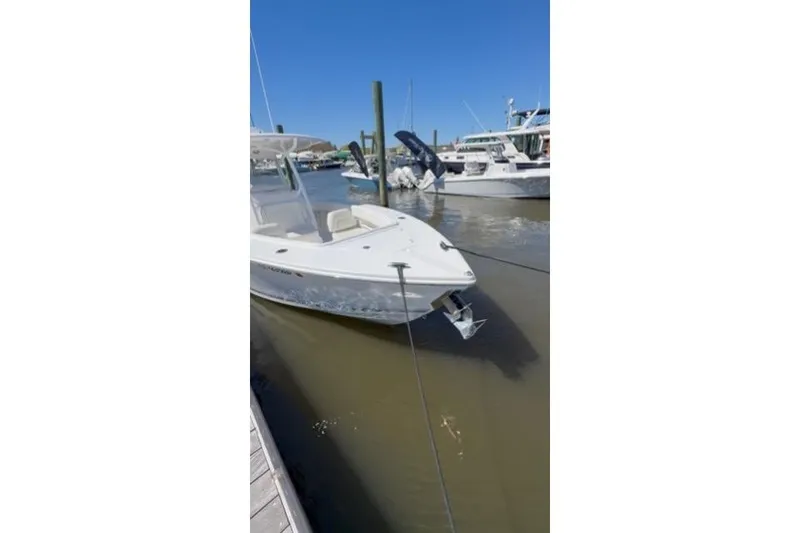 Slide: The Image of 2023 Jupiter 30 boat docked at marina under clear blue sky. - 58