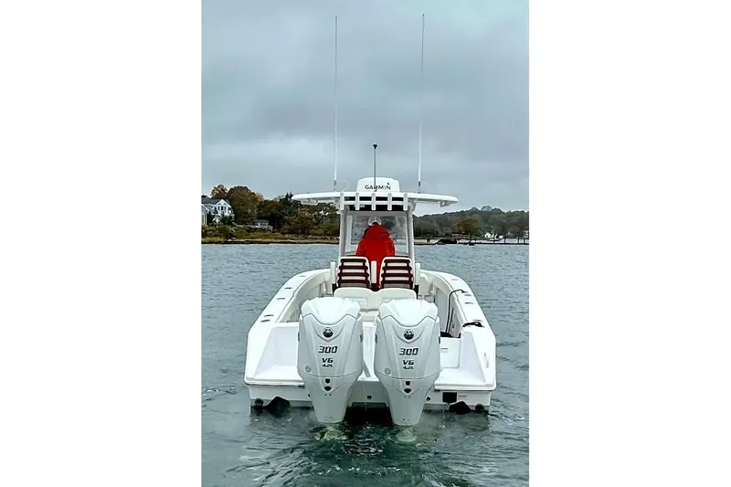 Slide: The Image of 2023 Jupiter 30 boat with dual 300 V6 engines on a cloudy day. - 6