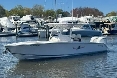 Slide: The Image of 2023 Jupiter 30 boat docked in marina with other vessels. - 60