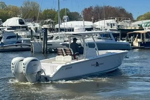 Slide: The Image of 2023 Jupiter 30 boat cruising in a marina with twin engines. - 61