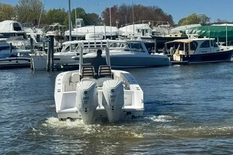 Slide: The Image of 2023 Jupiter 30 boat cruising in a marina with other vessels. - 67