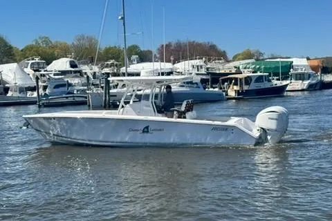 Slide: The Image of 2023 Jupiter 30 boat cruising in a marina with other vessels. - 68