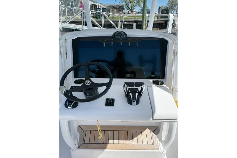 Slide: The Image of 2023 Jupiter 30 boat on a calm marina, surrounded by other vessels. - 70