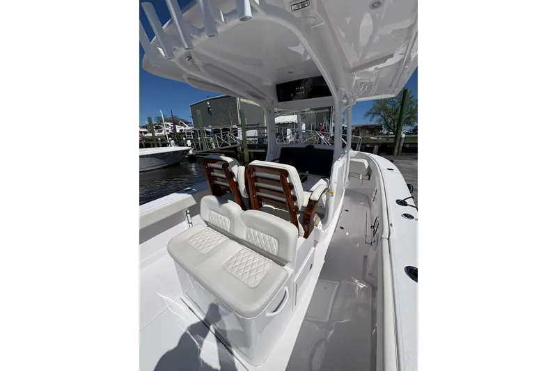Slide: The Image of 2023 Jupiter 30 boat interior with twin engines docked at marina. - 72