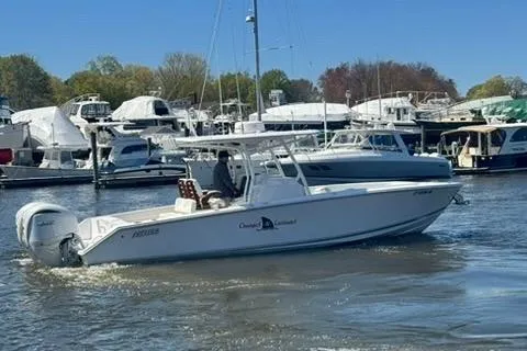 Slide: The Image of 2023 Jupiter 30 boat cruising in a marina with other vessels. - 75