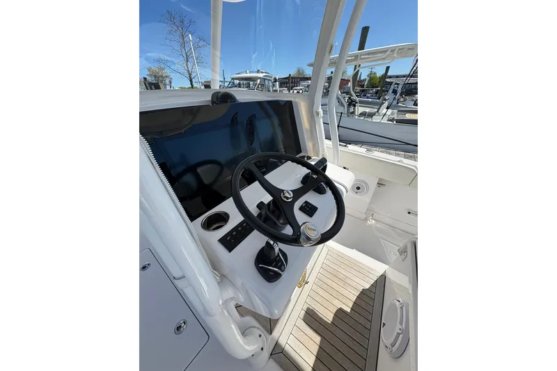 Slide: The Image of 2023 Jupiter 30 boat cruising in a marina with other vessels. - 77