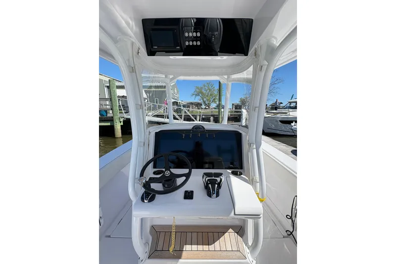 Slide: The Image of 2023 Jupiter 30 boat docked in a marina with other vessels. - 81